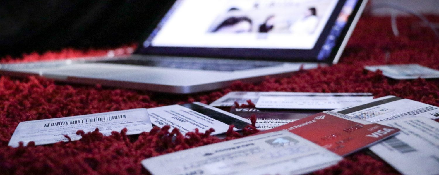 laptop sitting on blanket with credit cards around it